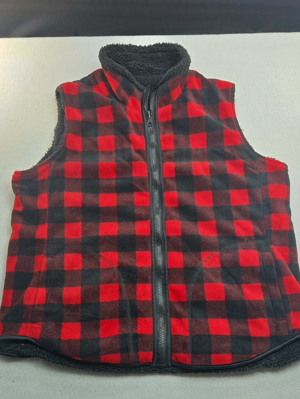 Reversible Red and black buffalo plaid sherpa vest, reverses to all black.